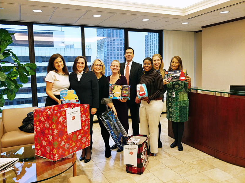 Cuddy and Feder employees posing with salvation army and toys collected